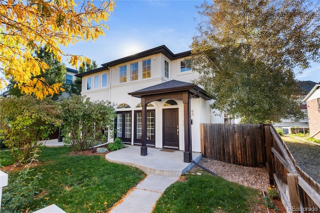 view of front of property with a front lawn and french doors