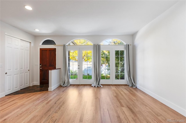 spare room with light wood-type flooring and french doors