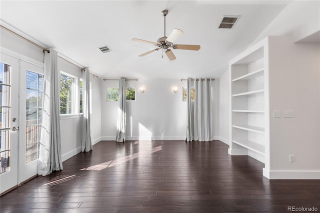 empty room featuring built in features, dark hardwood / wood-style floors, ceiling fan, and french doors