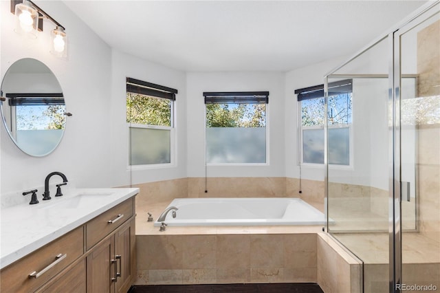 bathroom featuring vanity and independent shower and bath