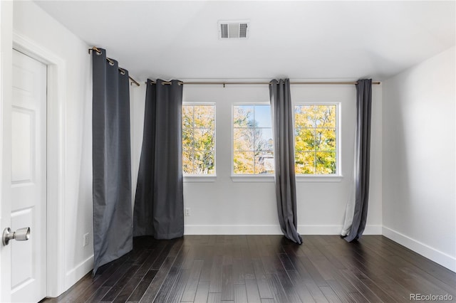 spare room with dark hardwood / wood-style flooring