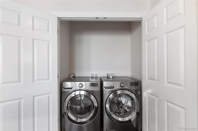 clothes washing area featuring washer and dryer