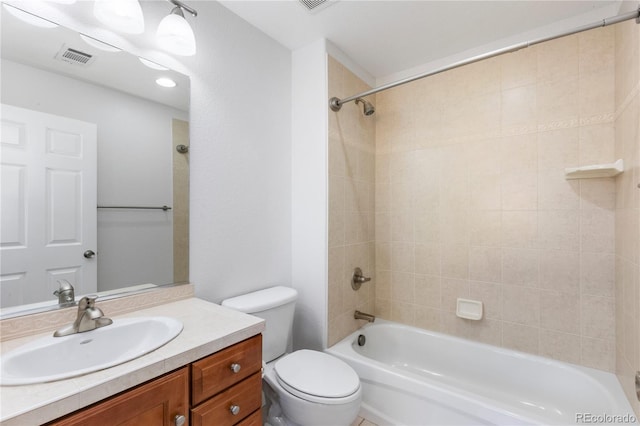 full bathroom with toilet, tiled shower / bath, and vanity