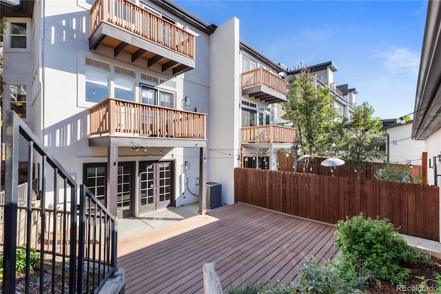 wooden terrace featuring a patio area and cooling unit