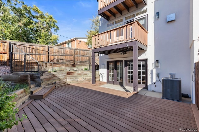 wooden terrace featuring french doors and central AC unit