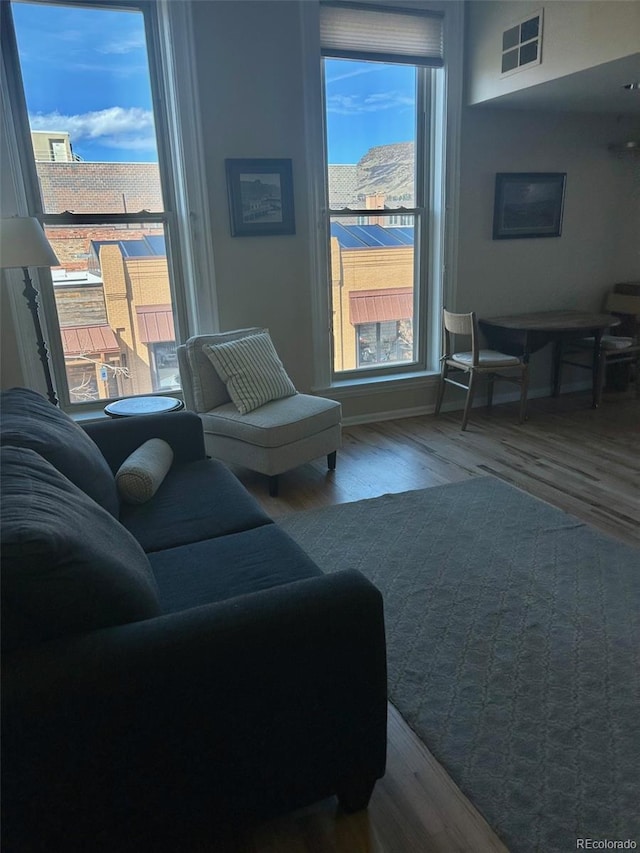 living room featuring wood finished floors and visible vents