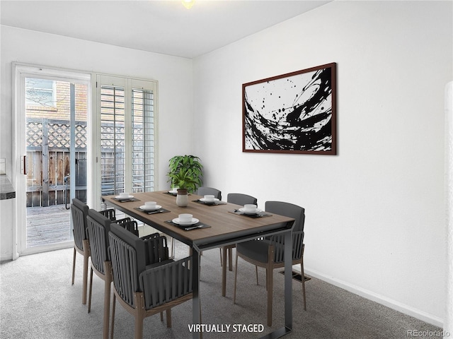 dining room with baseboards and carpet floors