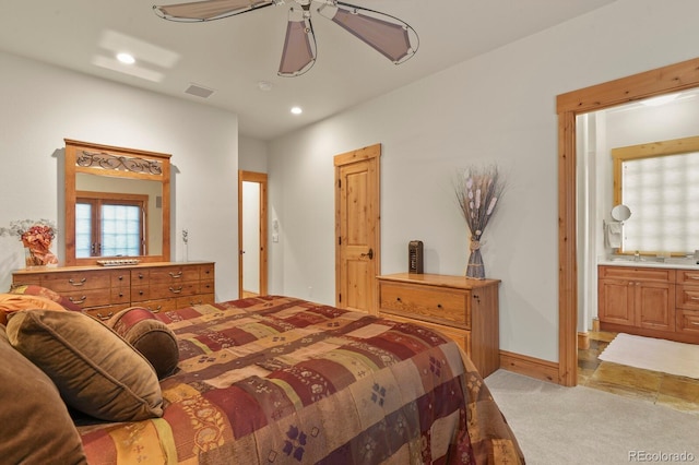 bedroom featuring light carpet, visible vents, baseboards, ensuite bath, and recessed lighting