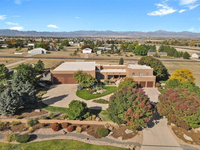 birds eye view of property with a mountain view