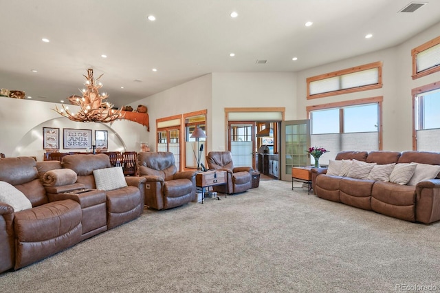 living room with recessed lighting, a towering ceiling, visible vents, carpet, and an inviting chandelier