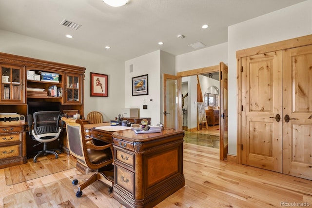 office space with recessed lighting, visible vents, and light wood-style flooring