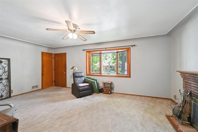 6050 Marshall Ct, Arvada, CO 80003 - living area featuring a ceiling fan, a brick fireplace, carpet flooring, and baseboards