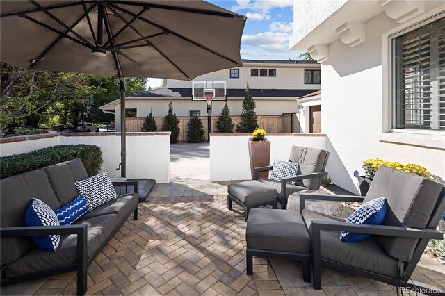 view of patio with fence and an outdoor living space