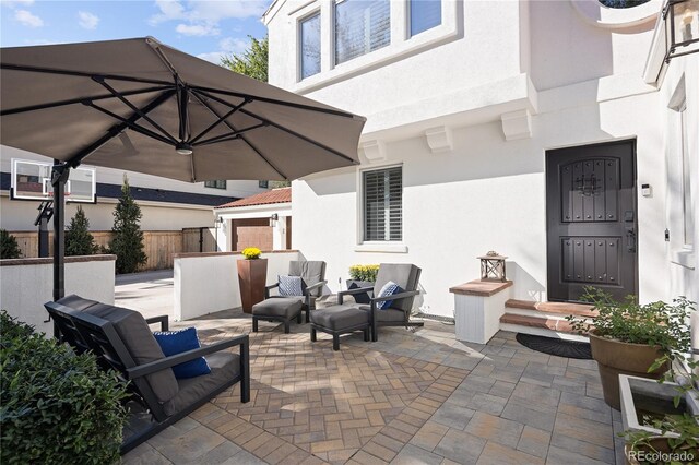 view of patio / terrace featuring fence and an outdoor hangout area