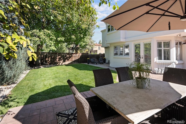 view of yard featuring a fenced backyard, a patio, and outdoor dining space