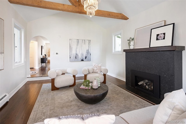living area featuring lofted ceiling with beams, dark wood-type flooring, baseboards, a baseboard heating unit, and arched walkways