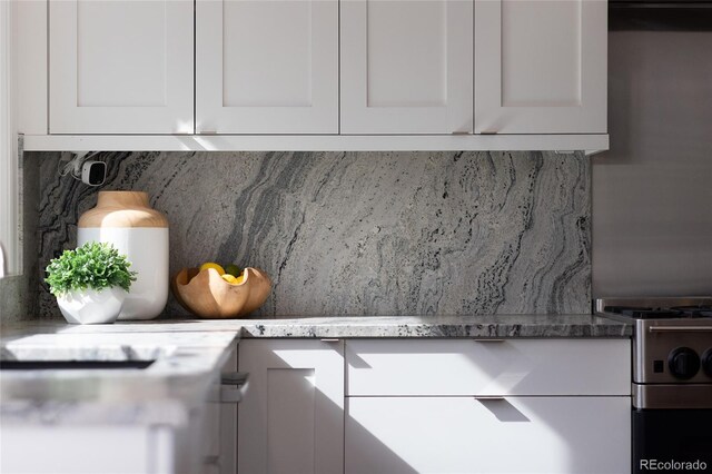 details featuring white cabinetry and tasteful backsplash