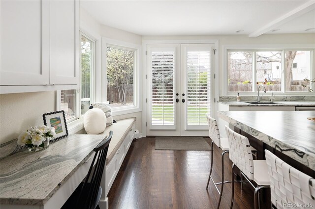 sunroom / solarium with french doors and a sink