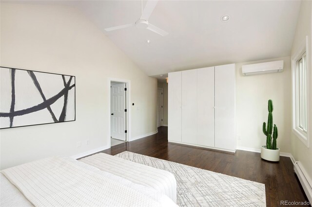 bedroom with a baseboard heating unit, baseboards, a wall mounted AC, and dark wood-type flooring