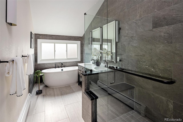 full bathroom with a soaking tub, baseboard heating, vanity, and a stall shower