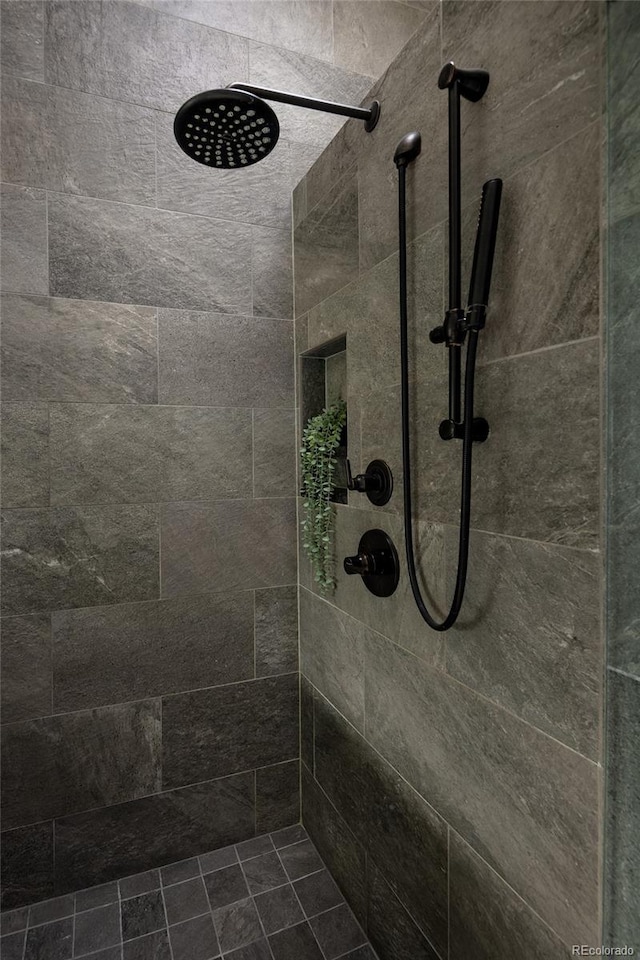 full bath with a tile shower