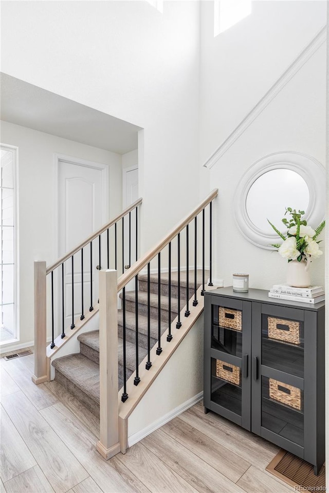 staircase with wood-type flooring