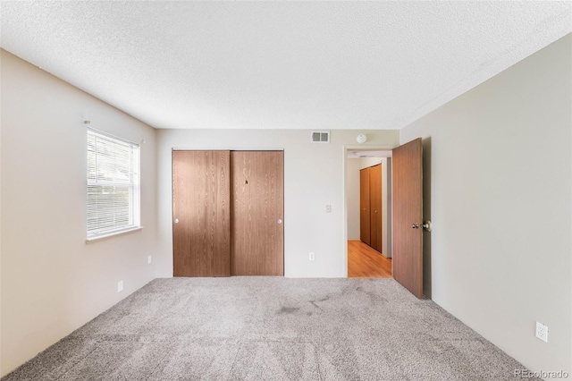4896 S Dudley St Unit 4-7, Littleton, CO 80123 - unfurnished bedroom with carpet flooring, a closet, and a textured ceiling