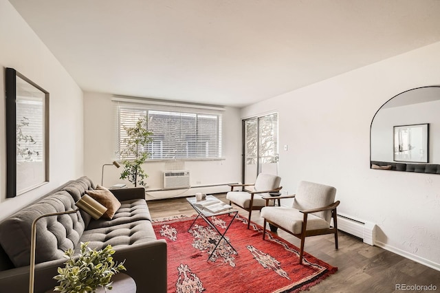 living area featuring a baseboard radiator, a wall mounted air conditioner, and wood finished floors