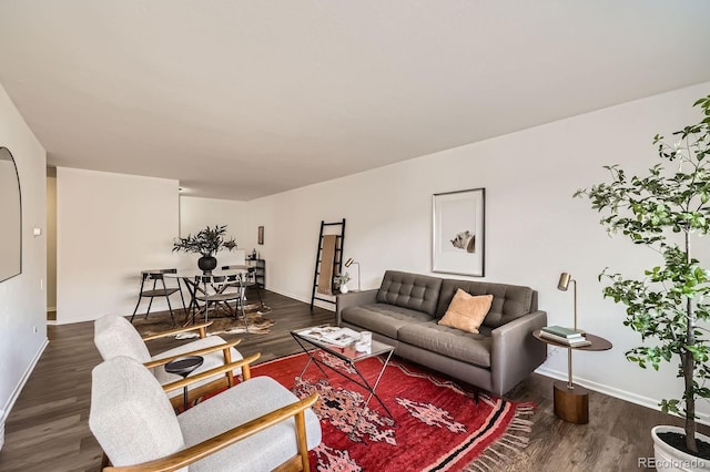 living room featuring dark wood finished floors and baseboards