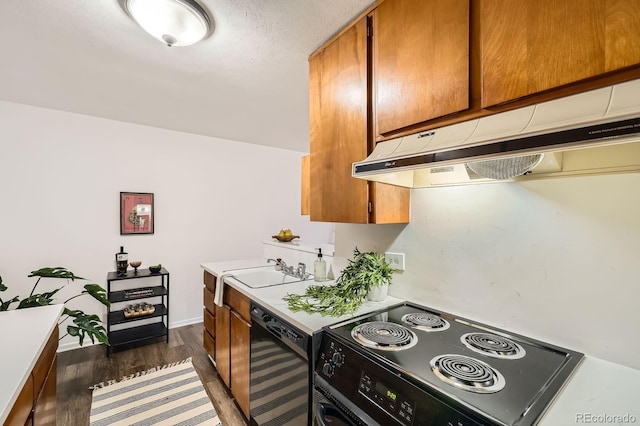 kitchen featuring black range with electric stovetop, under cabinet range hood, dishwashing machine, brown cabinetry, and a sink