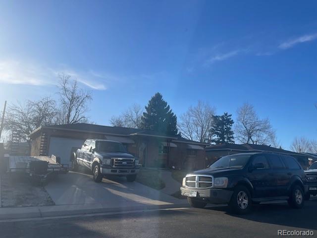 2285 S Newton St, Denver, CO 80219 - view of front facade featuring driveway and an attached garage