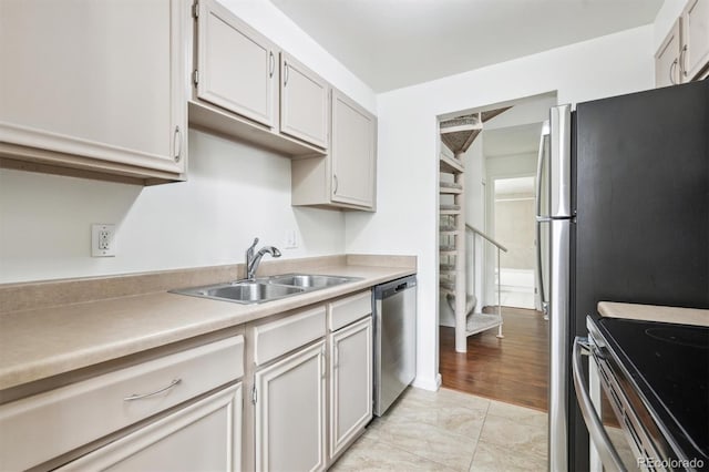 384 S Ironton St Unit 413, Aurora, CO 80012 - kitchen featuring stainless steel dishwasher, a sink, and light countertops