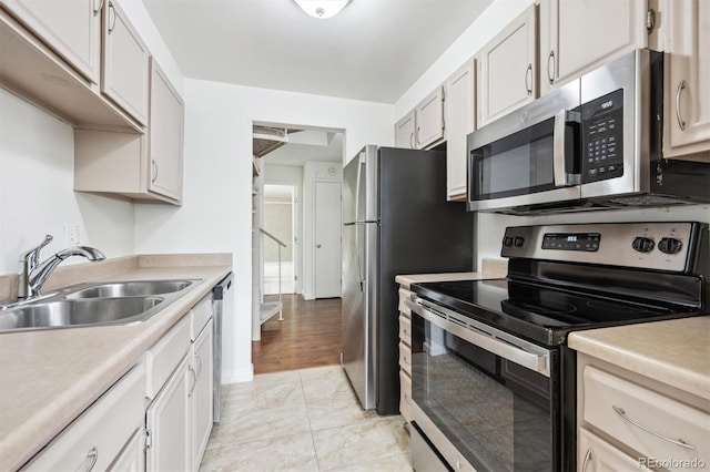 384 S Ironton St Unit 413, Aurora, CO 80012 - kitchen with appliances with stainless steel finishes, a sink, light countertops, and white cabinets