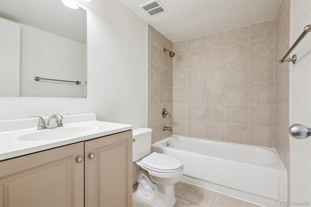 384 S Ironton St Unit 413, Aurora, CO 80012 - full bath featuring toilet, vanity, bathtub / shower combination, tile patterned floors, and a textured wall