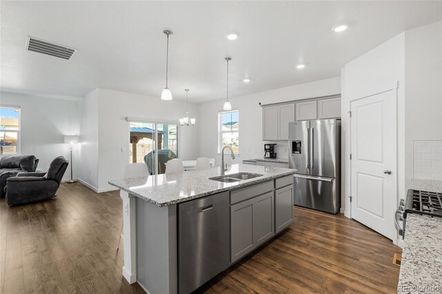 kitchen featuring gray cabinets, an island with sink, appliances with stainless steel finishes, and sink