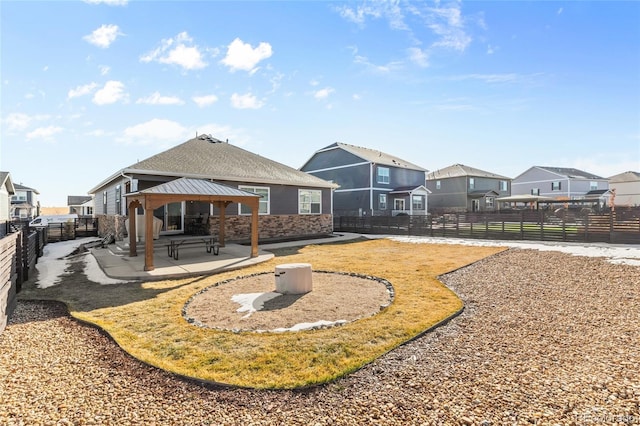 back of property featuring a gazebo and a patio area