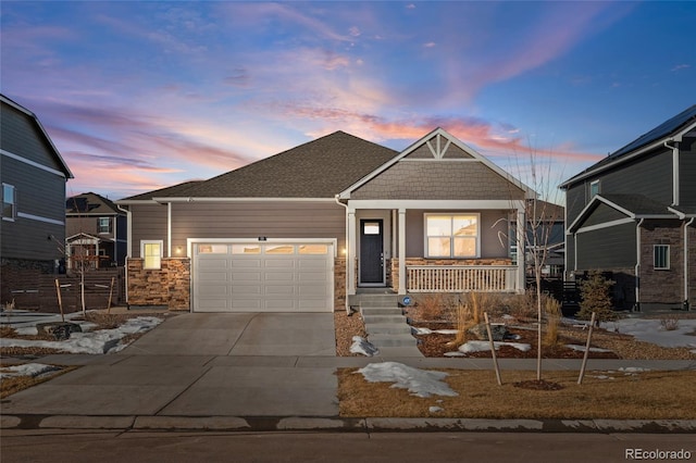 craftsman-style home featuring a porch and a garage