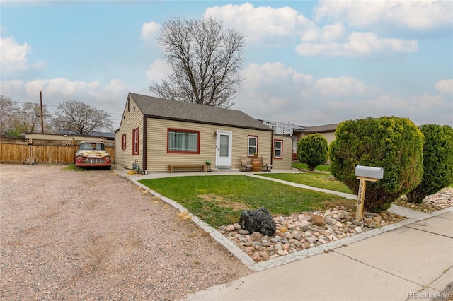 5910 Glencoe St, Commerce City, CO 80022 - bungalow-style house featuring a front lawn, driveway, and fence