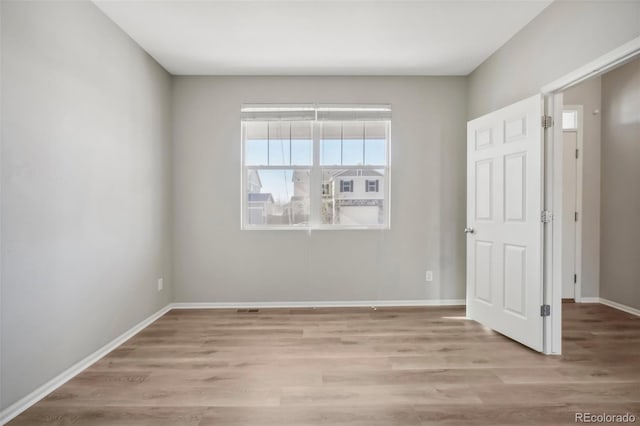 spare room with light hardwood / wood-style floors