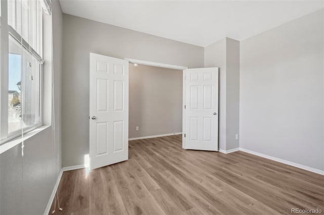 unfurnished bedroom with light wood-type flooring