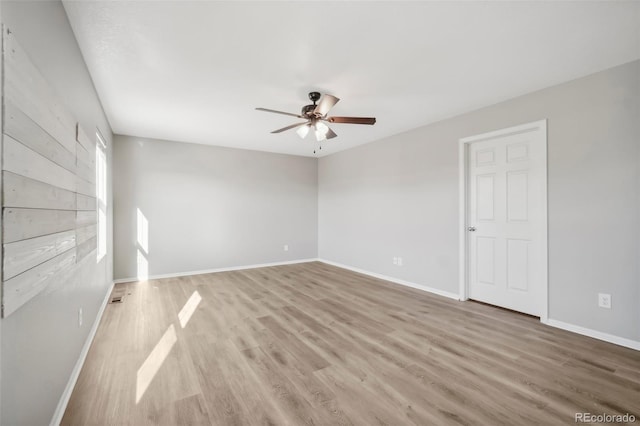 spare room with ceiling fan and light wood-type flooring