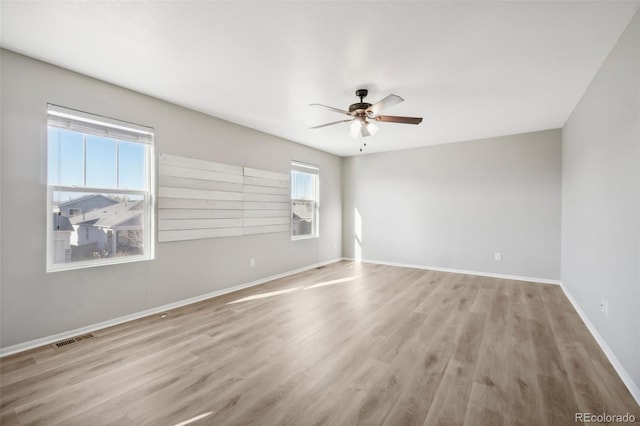 empty room with light hardwood / wood-style floors and ceiling fan