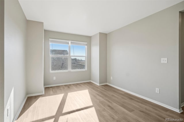 spare room with wood-type flooring