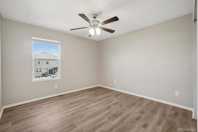 spare room featuring ceiling fan and hardwood / wood-style flooring