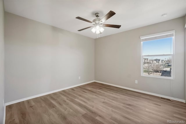 unfurnished room with wood-type flooring and ceiling fan