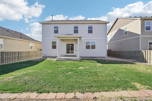 rear view of property featuring a yard