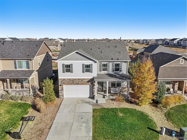 view of front property with a front lawn, a porch, and a garage