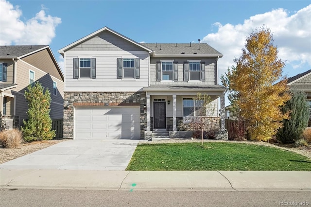 view of front of property with a porch, a garage, and a front lawn