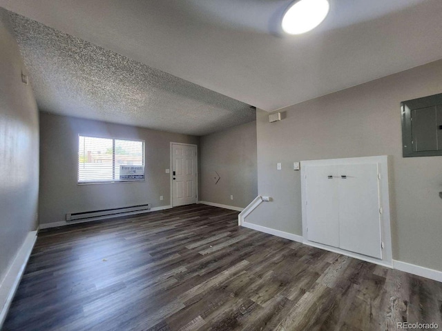 25 Castle Royal Dr, Pueblo, CO 81005 - empty room with a baseboard radiator, wood finished floors, baseboards, electric panel, and a textured ceiling