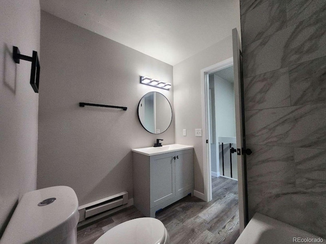 25 Castle Royal Dr, Pueblo, CO 81005 - bathroom featuring toilet, baseboard heating, wood finished floors, and vanity